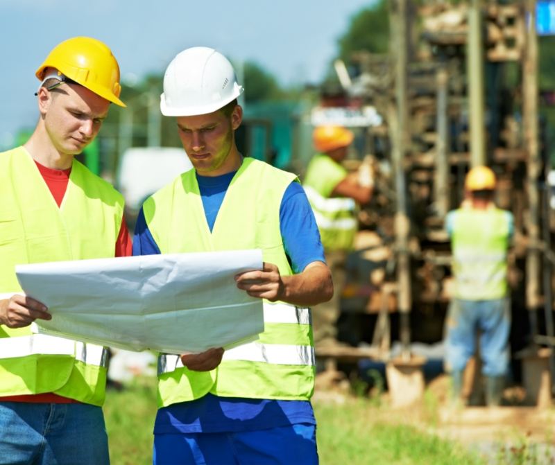 2 Workmen looking at Home Plans