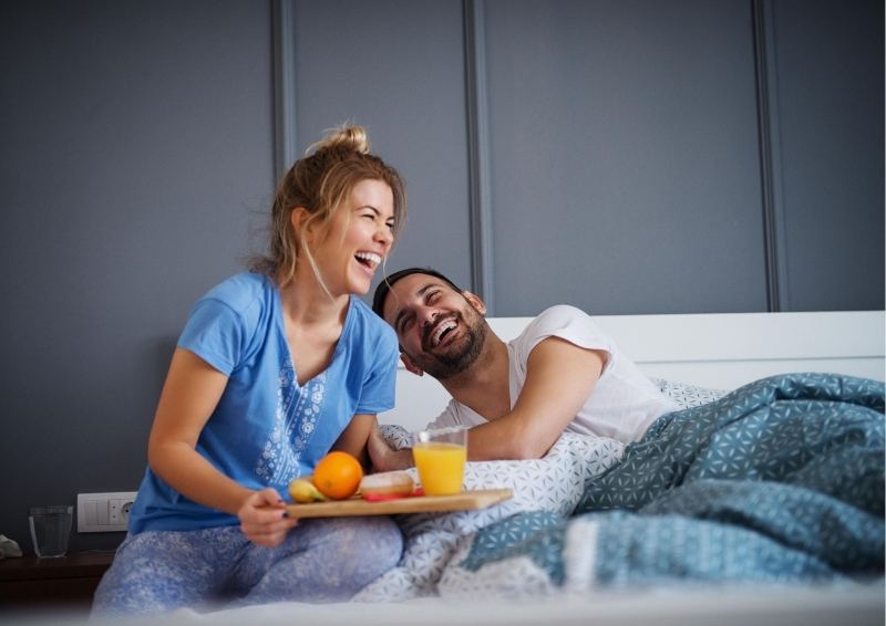 Couple having Breakfast bed In new home