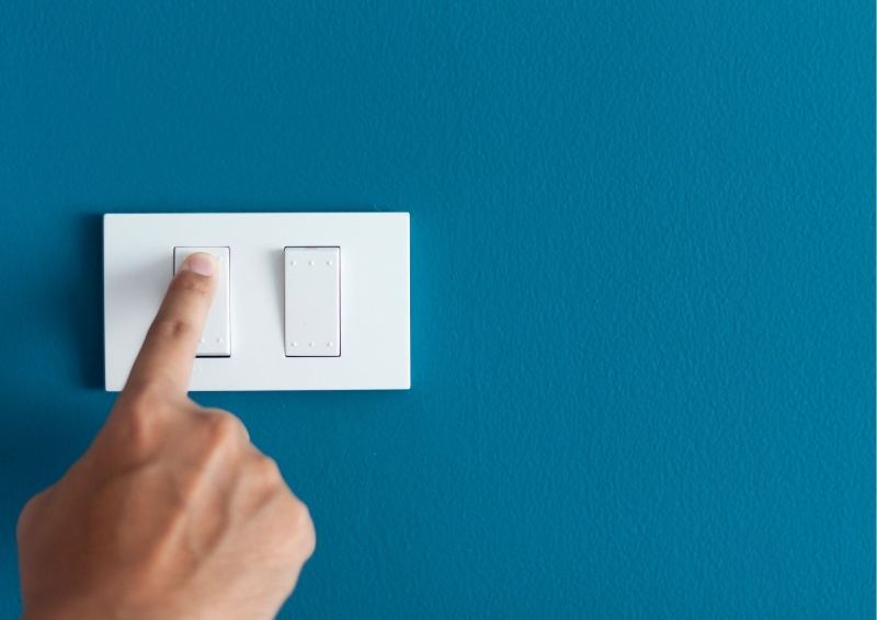 Turning on a light switch in your new Hunter Designer Home