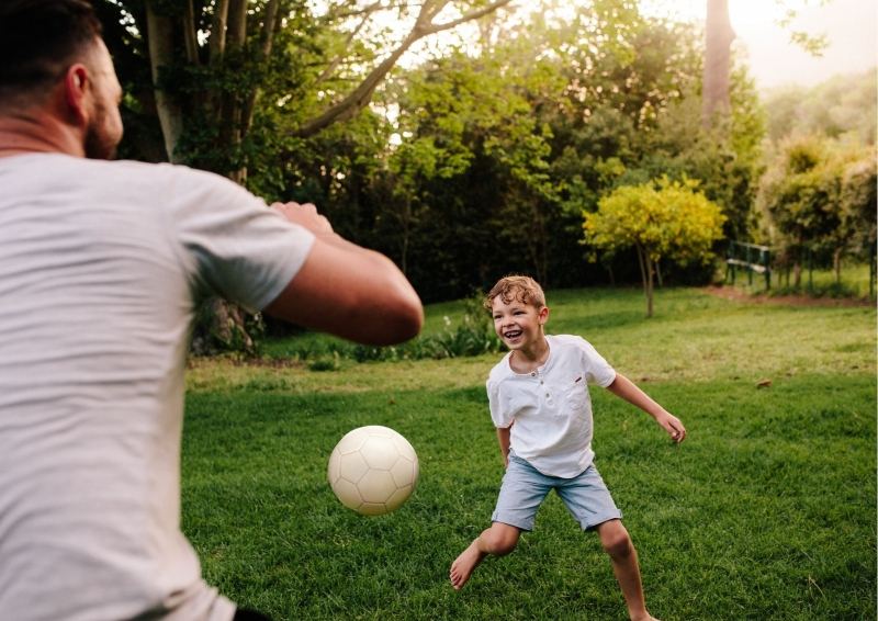 Father and Son playing Soccer