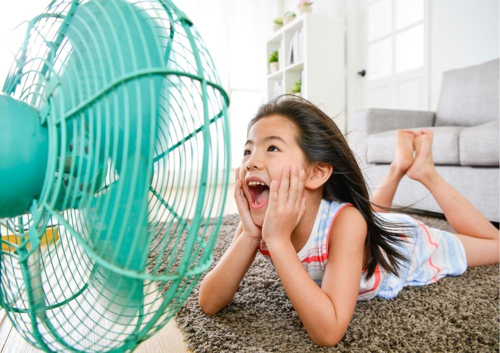 Girl Laying in front of fan