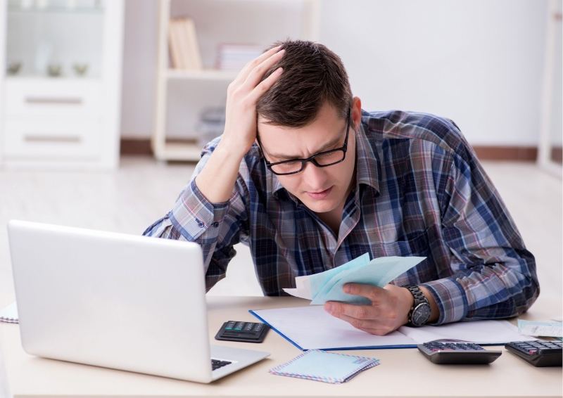 Guy looking at the cost of different types of Insulation.