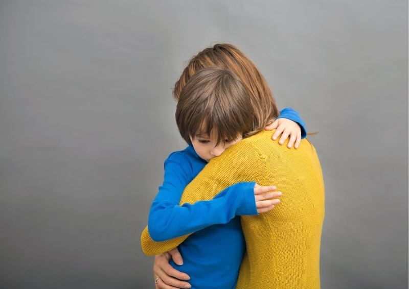 Mother hugging child