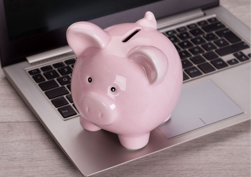 Pink Piggy Bank on Laptop