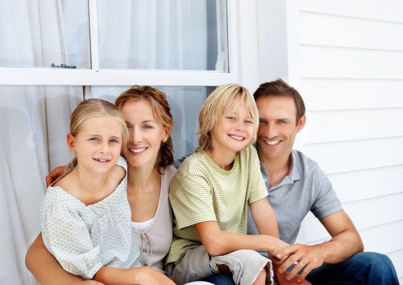 Family sitting in front of a window