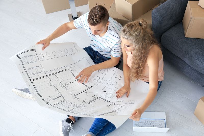 Couple looking at home plan designs
