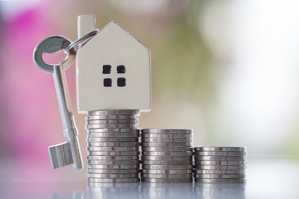 Stack of coins with House Key