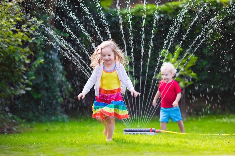 Kids running through Sprinkler