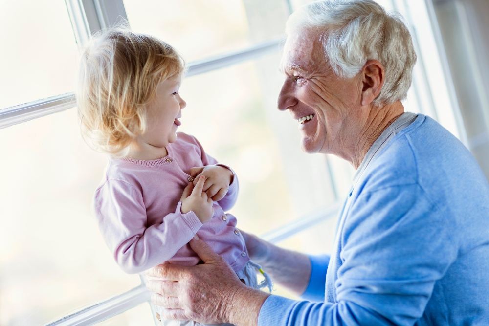 Senior Man holding Child