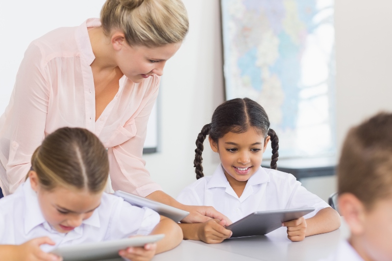 Teacher in classroom with kids